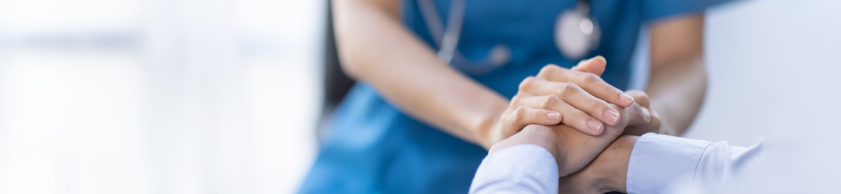 nurse holding a patient's hand