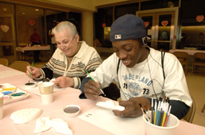 CC patient and his mother painting pottery.