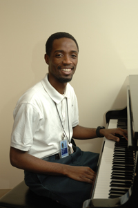 CC staff member playing the piano.