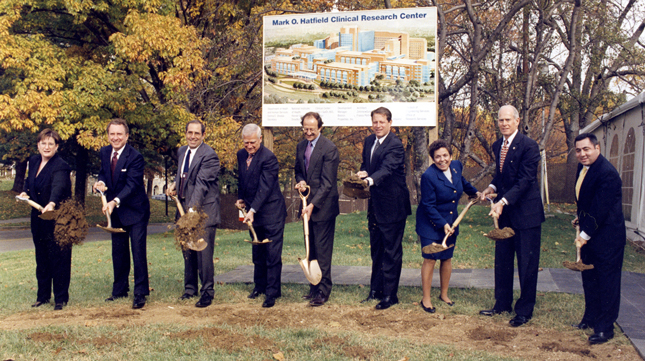Ceremonial groundbreaking for the new Clinical Research Center in 1997, which include (from left) CC patient Jane Reese-Coulbourne, Sen. Arlen Specter (R-Pa), CC Director Dr. John I. Gallin, Sen. Mark O. Hatfield (R-Ore), NIH Director Dr. Harold Varmus, U.S. Vice President Al Gore, HHS Secretary Donna Shalala, Rep. John Porter (R-Ill), and CC patient Charles Tolchin