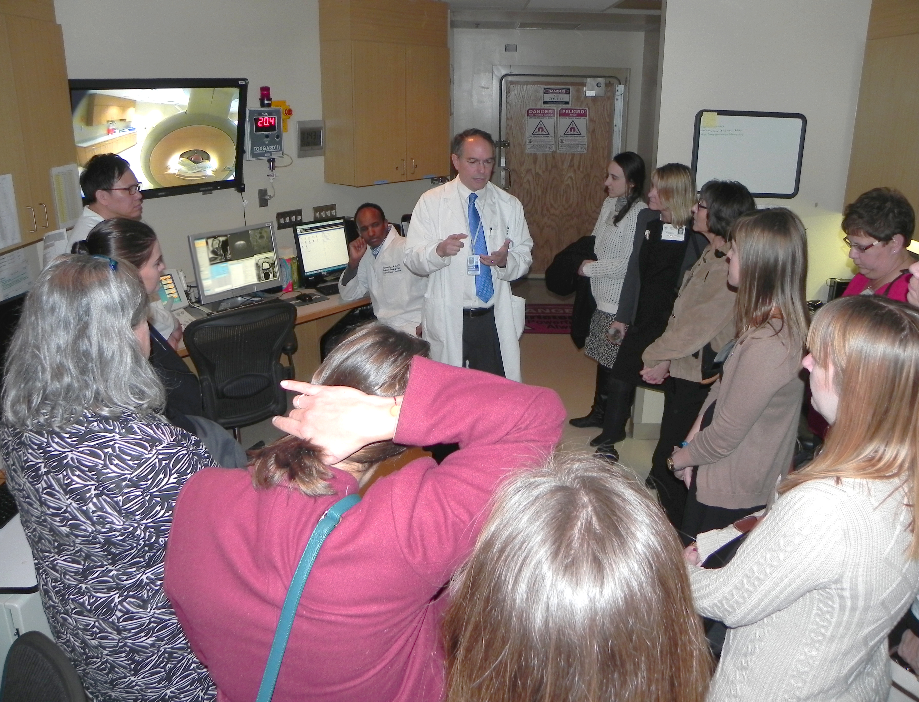 Dr. Pete Choyke discusses his research with fifteen members of the Oncology Nursing Society.