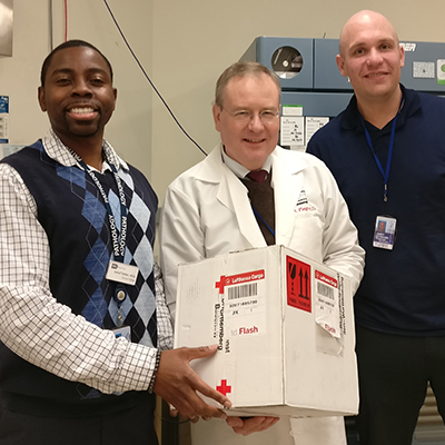 Three Department of Transfusion Medicine staff members receive a package of rare blood from Germany