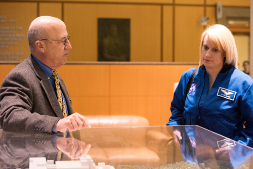 Clinical Center CEO Dr. James Gilman shows NASA astronaut—scientist Dr. Kate Rubins a model of the hospital.