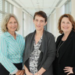 Karen Baker, Dr. Colleen Hadigan and Victoria Anderson stand in a hallway.