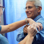 A nurse provides Dr. Anthony Fauci a flu shot