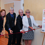 Senior leaders at NIH cut a ribbon opening two hospice suites at the Clinical Center
