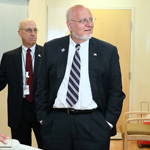 CDC and NIH representatives stand in a special isolation patient room at the NIH Clinical Center