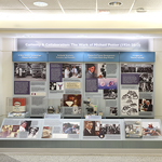 A four panel exhibit with photos, text and artifacts on NIH medical pioneers Christian Anfinsen and Michael Potter