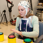 Woman with scientific cap on her head plays a touch game