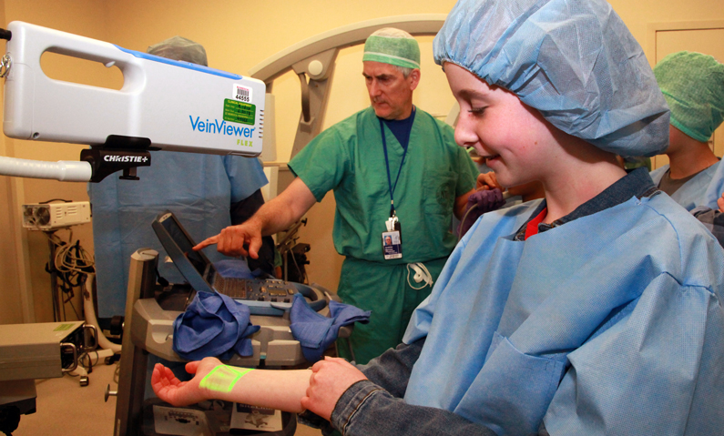 Child participates in Take Your Child to Work Day Operating Room Boot Camp activity