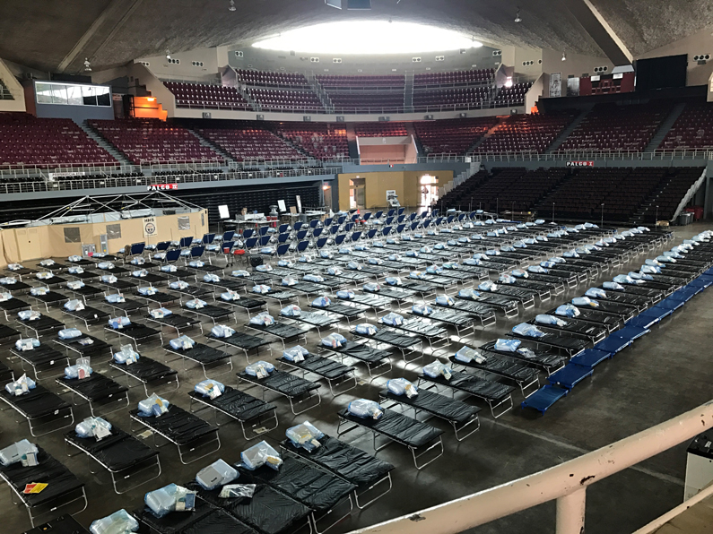 Empty cots await those in need in the field medical station based in a repurposed basketball stadium