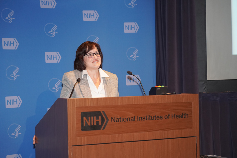 Lisa Danielpour speaks from a podium at the 2018 NIH Health Information Technology Day Oct. 12 at the NIH Clinical Center