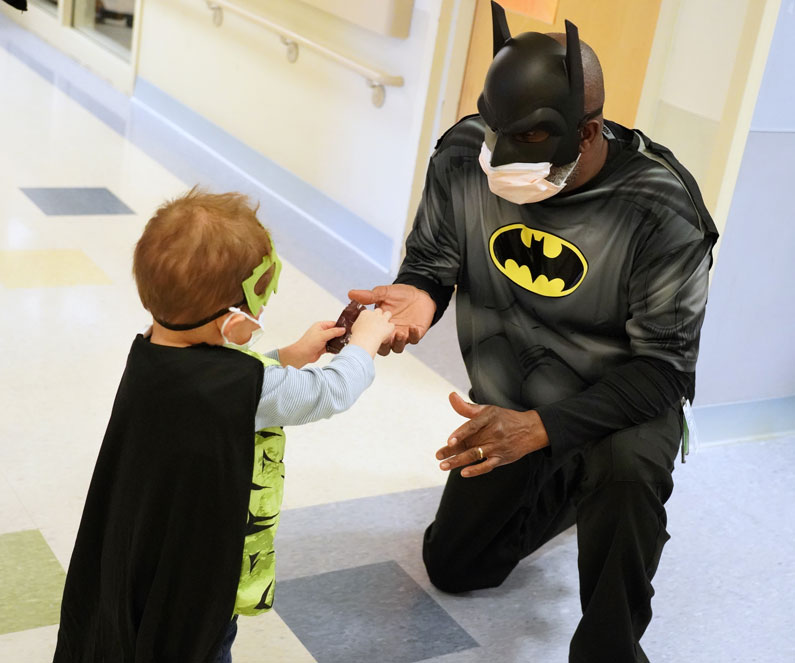 Clinical Center patient Tiago shared his candy with pediatric nurse Jesse Strowbridge, dressed as a Batman