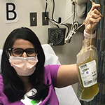 Healthy volunteer Tanvee Singh holding plasma she's donating