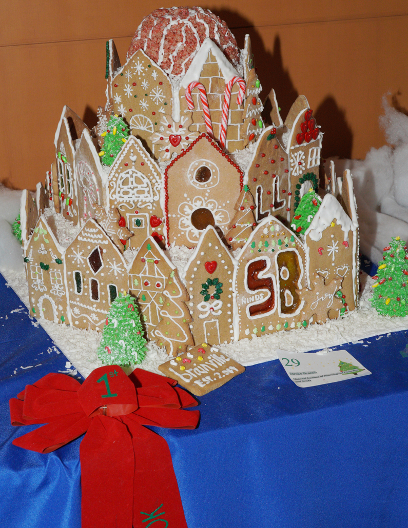 This is a two-tiered gingerbread house with a brain sitting atop it