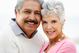 an elderly couple smiling